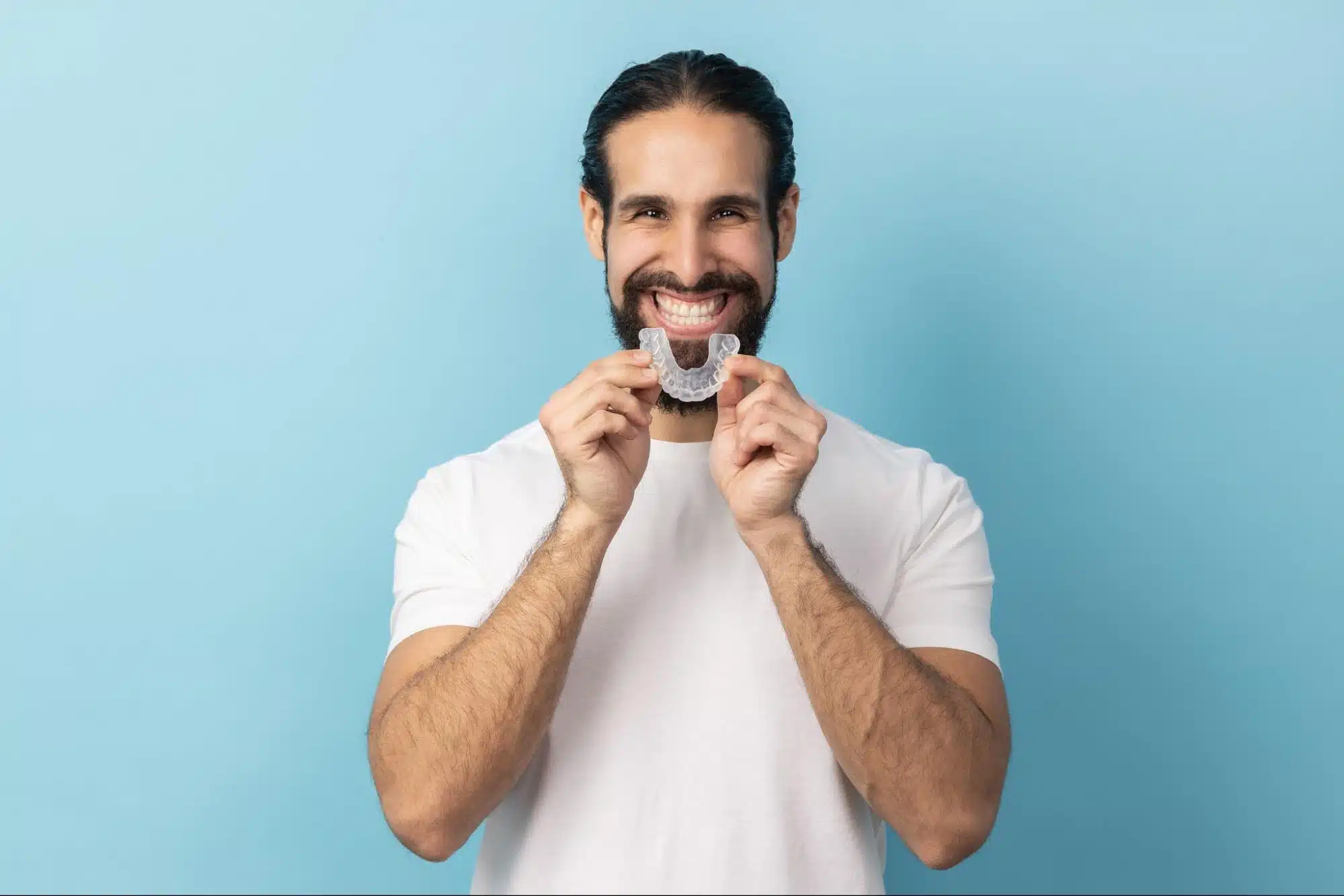 Man smiling with clear retainer
